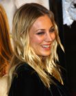 Kaley Cuoco sporting long blonde hair that was styled by hands