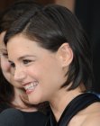 Katie Holmes sporting a bob with the sides of her hair tucked behind her ears