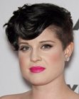 Kelly Osbourne with her hair cut very short and around her ears