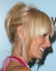 Kimberly Stewart with her blonde hair with bangs styled into an updo