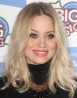 Kimberly Wyatt sporting a long hairstyle with the hair curled away from the face