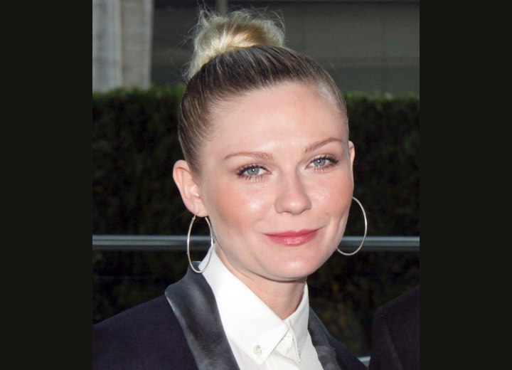 Kirsten Dunst - Hair in a tight bun and a buttoned up blouse