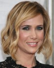 Krsiten Wiig's medium length bob hairstyle with spiral curls