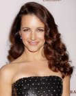 Brunette Kristin Davis wearing her hair long with cascading curls