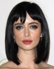 Krysten Ritter wearing her hair in a slightly tilted neck-length bob with bangs
