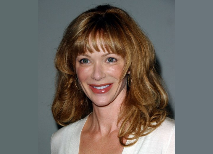 Lauren Holly with long curled hair