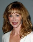 Lauren Holly's bouncy long hair with layers and big curls