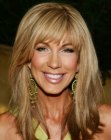 Leeza Gibbons with her long hair cut into smooth layers