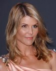 Lori Loughlin with her long hair styled for a windswept effect