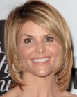 Lori Loughlin wearing a medium length asymmetrical hairstyle that frames her face