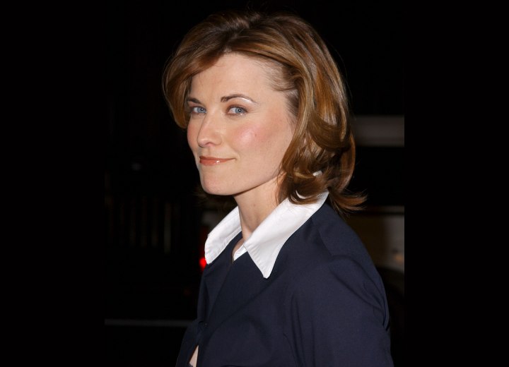 Side view of Lucy Lawless medium length haircut