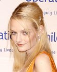 Lydia Hearst wearing her long hair straight and styled towards the back