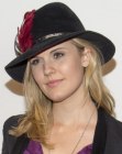Maggie Grace pairing her long and layered blonde hair with a hat