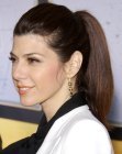 Marisa Tomei with her long hair styled up in a business look ponytail
