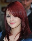 Megan Prescott's long red hair styled with a dip below her eye