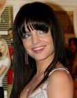 Mena Suvari sporting long and shiny black hair with arched bangs