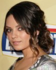 Mila Kunis wearing her hair up in a formal style