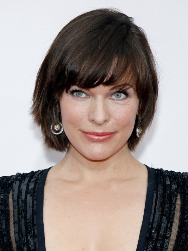 Milla Jovovich with her hair cut in a sleek short style with helmet shape