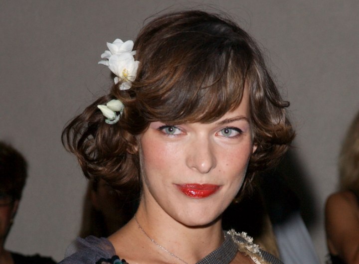 Milla Jovovich wearing her hair styled into curls