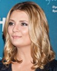 Mischa Barton wearing a shoulder length hairstyle with flattering loose curls