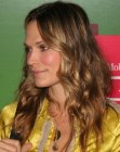 Molly Sims wearing her curly hair in an easy long style