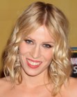 Natasha Bedingfield wearing blonde shoulder length hair with curls