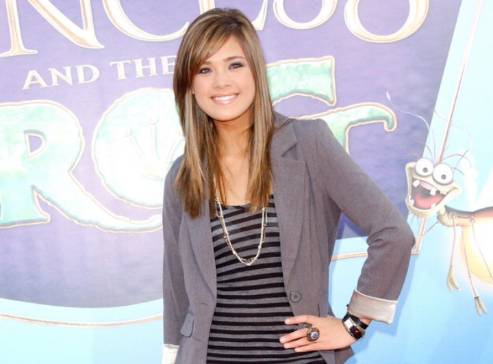 Nicole Anderson wearing dark heans, striped tee and gray blazer