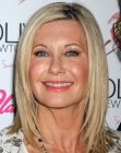 Olivia Newton John wearing her hair sleek and cut at the shoulder line