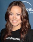 Olivia Wilde sporting long hair with curls that begin around the eyebrows