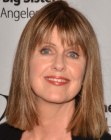 Pam Dawber sporting a sleek medium length haircut with bangs