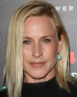 Patricia Arquette with her hair tucked behind one ear