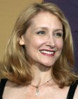 Patricia Clarkson wearing her mid-length blonde hair in loose curls