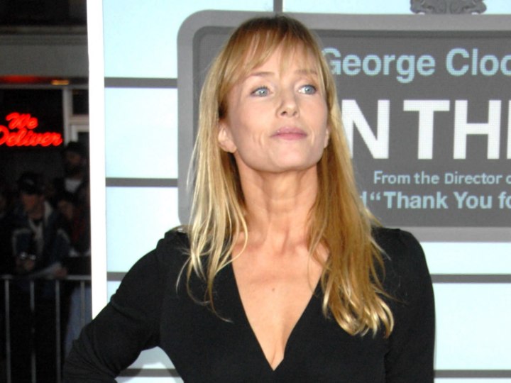 Rebecca de Mornay with long hair and bangs that fall just 