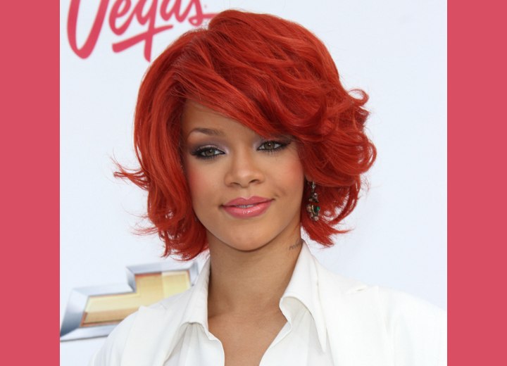 Rihanna  Neck length hairstyle and a fiery red hair color