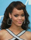 Rihanna's long hairstyle with a side swept quiff and curls