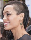 Rosario Dawson with half of her head shaved to buzzcut length