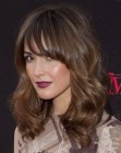 Rose Byrne sporting long hair with heavy bangs and curled ends