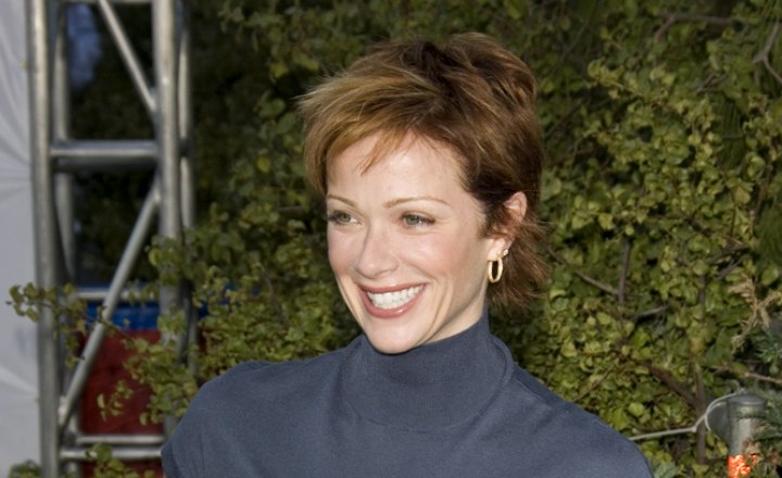 Lauren Holly sporting short, layered red hair