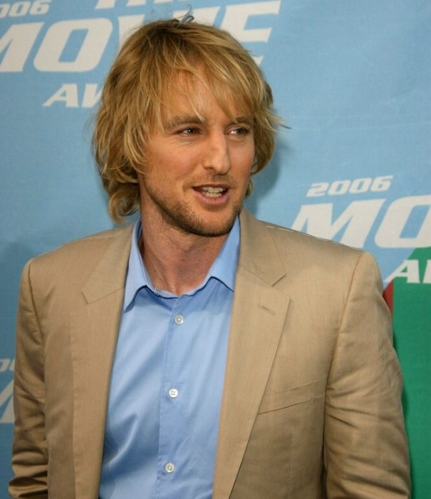 Owen Wilson sporting a long layered haircut, styled to 