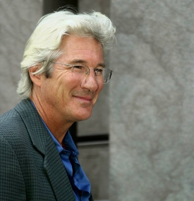 Richard Gere with silver hair and sporting a classic 