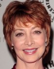 Sharon Lawrence's auburn pixie haircut with wispy pieces around the nape