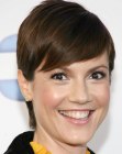 Zoe McLellan's elegant pixie haircut with her hair styled behind her ears