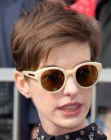 Anne Hathaway sporting a disheveled pixie with stacked layers