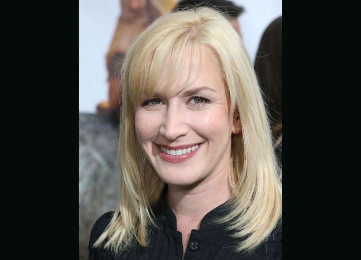 Angela Kinsey with sleek hair and bangs