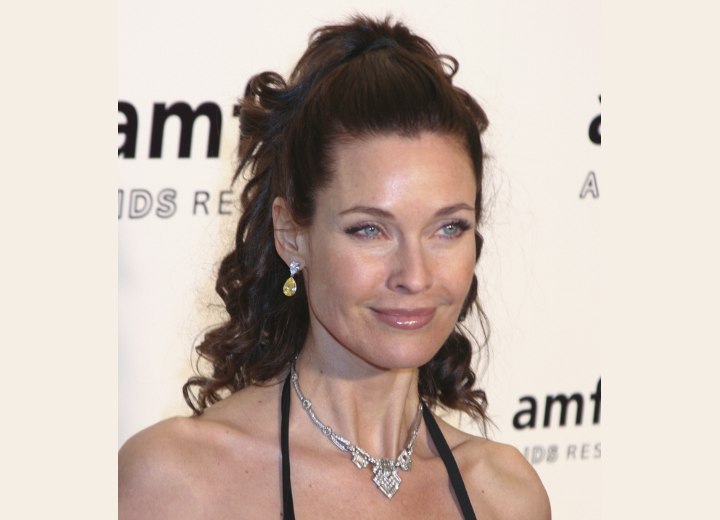 Carol Alt wearing her hair in a partial up-style with a cascade of curls