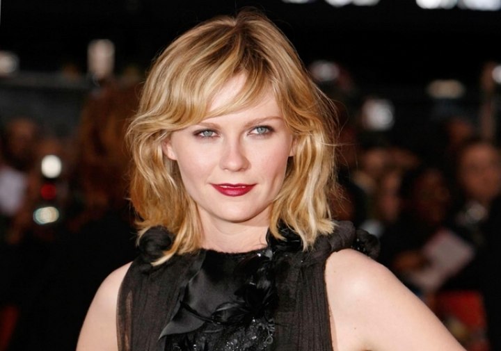 Kirsten Dunst's medium length hairstyle with bouncy curls