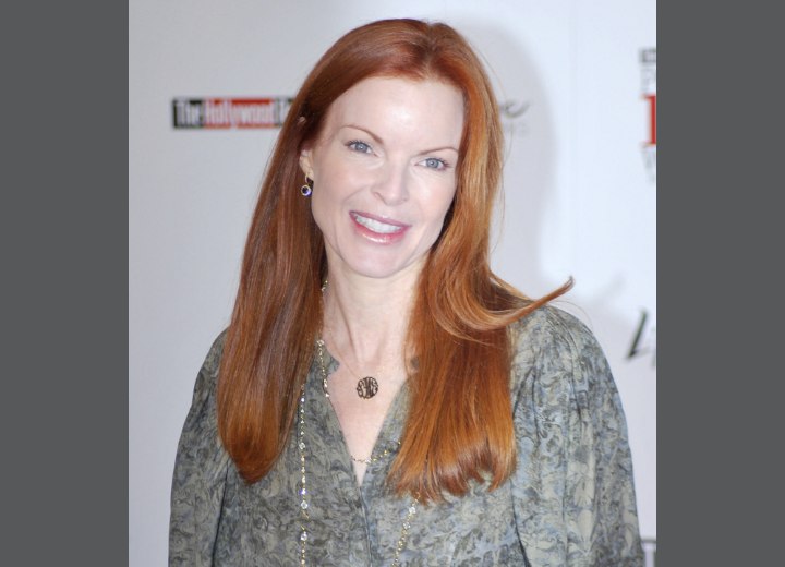 Marcia Cross wearing a long red blunt haircut