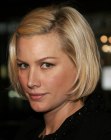 Alice Evans wearing her blonde hair in a blunt bob with a side part