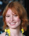 Alicia Witt with her red hair cut into a mid-length style with layers