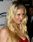 Anna Kournikova with her very long blonde hair styled into waves